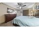 Relaxing bedroom with large bed, dark wood furnishings, neutral walls and carpet at 1150 N Buffalo Dr # 1007, Las Vegas, NV 89128