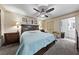 Comfortable bedroom featuring a spacious bed, ceiling fan, and an ensuite bathroom with generous counter space at 1150 N Buffalo Dr # 1007, Las Vegas, NV 89128