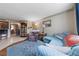 Open living room with a blue sofa, blue rug, and seamless access to the kitchen at 1150 N Buffalo Dr # 1007, Las Vegas, NV 89128