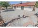 Backyard featuring a rock landscape, privacy wall, and mature tree at 134 Saint Albans Dr, Henderson, NV 89015