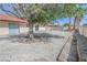 Backyard featuring a rock landscape, mature trees, and a privacy wall at 134 Saint Albans Dr, Henderson, NV 89015
