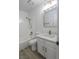 Bathroom with a white single sink vanity, gold hardware, and white tile tub with shower at 134 Saint Albans Dr, Henderson, NV 89015