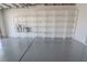 Garage features bright lighting, epoxy flooring, and built-in shelving at 134 Saint Albans Dr, Henderson, NV 89015