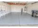 Spacious garage featuring epoxy flooring, built in shelving, and utility access at 134 Saint Albans Dr, Henderson, NV 89015