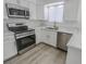 Renovated kitchen featuring stainless steel appliances, modern white cabinetry, and beautiful countertop space at 134 Saint Albans Dr, Henderson, NV 89015