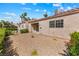 The gravel backyard features mature landscaping and a private outdoor space at 1411 Di Blasi Dr # 104, Las Vegas, NV 89119