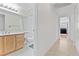 Hallway view of bathroom with neutral-toned vanity and tile floors at 1411 Di Blasi Dr # 104, Las Vegas, NV 89119