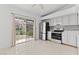 Bright eat-in kitchen featuring modern appliances, tile flooring, and access to the outdoor patio at 1411 Di Blasi Dr # 104, Las Vegas, NV 89119