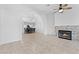 Bright living room featuring tile flooring, a fireplace with stone surround, and a ceiling fan at 1411 Di Blasi Dr # 104, Las Vegas, NV 89119