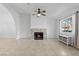 Spacious living room with stone fireplace, ceiling fan, and natural light at 1411 Di Blasi Dr # 104, Las Vegas, NV 89119