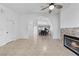 Spacious living room with tile floors, a fireplace, and an open layout that flows seamlessly into the dining area at 1411 Di Blasi Dr # 104, Las Vegas, NV 89119