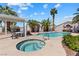 Community pool featuring a jacuzzi, shaded cabana, and tropical landscaping at 1411 Di Blasi Dr # 104, Las Vegas, NV 89119