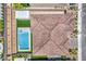Aerial view showcases backyard swimming pool, patio area, desert landscaping, and terracotta tile roof at 201 Carmel Sky St, Las Vegas, NV 89138