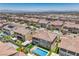 Aerial view of home showcasing backyard pool, covered patio, synthetic grass, and lush landscaping at 201 Carmel Sky St, Las Vegas, NV 89138