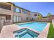 Sparkling pool and spa are bordered by turf and concrete patio at 201 Carmel Sky St, Las Vegas, NV 89138