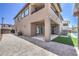 Beautiful backyard featuring a covered patio, small grassy area, stone pavers, and partial view of the pool at 201 Carmel Sky St, Las Vegas, NV 89138