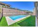 Backyard pool and spa are bordered by turf and concrete patio at 201 Carmel Sky St, Las Vegas, NV 89138