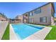 Exterior view of backyard pool and spa, with turf, retaining wall, and patio at 201 Carmel Sky St, Las Vegas, NV 89138