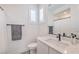 Bathroom with black fixtures, a white vanity, and decorative tile flooring at 201 Carmel Sky St, Las Vegas, NV 89138