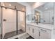 Contemporary bathroom boasts a glass-enclosed shower, double vanity, and stylish tile floors at 201 Carmel Sky St, Las Vegas, NV 89138
