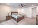 Spacious bedroom features a ceiling fan, a wooden bed frame, and a charming baby crib at 201 Carmel Sky St, Las Vegas, NV 89138