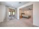 Bright, spacious bedroom flows to sitting area with wooden shutters and sliding glass doors to patio at 201 Carmel Sky St, Las Vegas, NV 89138