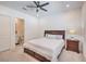 Bedroom boasts a ceiling fan, a view into the ensuite bath, and a bedside table at 201 Carmel Sky St, Las Vegas, NV 89138