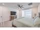 Bedroom with a large bed, a ceiling fan, sitting area, and a cabinet with a television at 201 Carmel Sky St, Las Vegas, NV 89138