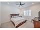 Bedroom features a ceiling fan, window with shutters, and a bed with storage drawers at 201 Carmel Sky St, Las Vegas, NV 89138