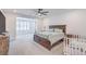 Large bedroom with a ceiling fan and sitting area that has a window with wooden shutters at 201 Carmel Sky St, Las Vegas, NV 89138