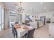 Open-concept dining room featuring stylish lighting with views to the kitchen and backyard at 201 Carmel Sky St, Las Vegas, NV 89138