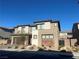 Two-story home with a modern design, desert landscaping, brick driveway, and an attached two-car garage at 201 Carmel Sky St, Las Vegas, NV 89138
