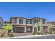 Beautifully landscaped modern two-story home showcasing a two-car garage and desert plants at 201 Carmel Sky St, Las Vegas, NV 89138
