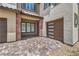 Paver driveway leads to a modern two-car garage and covered porch with brick accents at 201 Carmel Sky St, Las Vegas, NV 89138