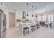 Open-concept kitchen features white cabinets, stainless steel appliances, and a large island with seating at 201 Carmel Sky St, Las Vegas, NV 89138