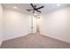 Spacious living room featuring double doors and a modern ceiling fan at 201 Carmel Sky St, Las Vegas, NV 89138