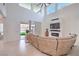 Bright open-concept living room with a fireplace, high ceilings, and sliding door access to the backyard at 201 Carmel Sky St, Las Vegas, NV 89138