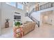Modern living room with a fireplace, a view of the staircase and large windows for natural light at 201 Carmel Sky St, Las Vegas, NV 89138