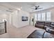Living room with a leather sectional couch, a mounted TV, and shuttered windows at 201 Carmel Sky St, Las Vegas, NV 89138