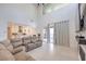 Bright living room with high ceilings flows into a modern kitchen and has sliding doors to the backyard at 201 Carmel Sky St, Las Vegas, NV 89138