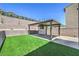 View of covered patio and outdoor kitchen, with tiered retaining wall at 201 Carmel Sky St, Las Vegas, NV 89138