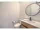 Stylish powder room features a modern vanity with a round mirror and contemporary fixtures at 201 Carmel Sky St, Las Vegas, NV 89138