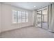 A bright, spacious sitting area with natural light that includes wooden shutters and sliding glass doors at 201 Carmel Sky St, Las Vegas, NV 89138
