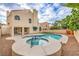 Backyard with a large pool and spa, surrounded by a patio and well-maintained landscaping at 2107 Fountain Springs Dr, Henderson, NV 89074
