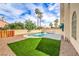 Lush backyard features a sparkling pool, spa, and vibrant green grass, perfect for relaxation and outdoor enjoyment at 2107 Fountain Springs Dr, Henderson, NV 89074