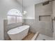 Modern bathroom featuring a standalone tub, a large window, and walk in shower at 2107 Fountain Springs Dr, Henderson, NV 89074