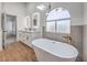 Modern bathroom featuring a standalone tub, double vanity, and stylish light fixtures at 2107 Fountain Springs Dr, Henderson, NV 89074