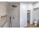 Modern shower with gray tile, a rainfall shower head, and a built-in shelf at 2107 Fountain Springs Dr, Henderson, NV 89074