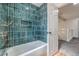 Stylish renovated bathroom features turquoise tile, a built-in niche, and modern fixtures at 2107 Fountain Springs Dr, Henderson, NV 89074