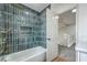 Upstairs bathroom with stylish blue tile in shower, and a view of the landing and stairs at 2107 Fountain Springs Dr, Henderson, NV 89074
